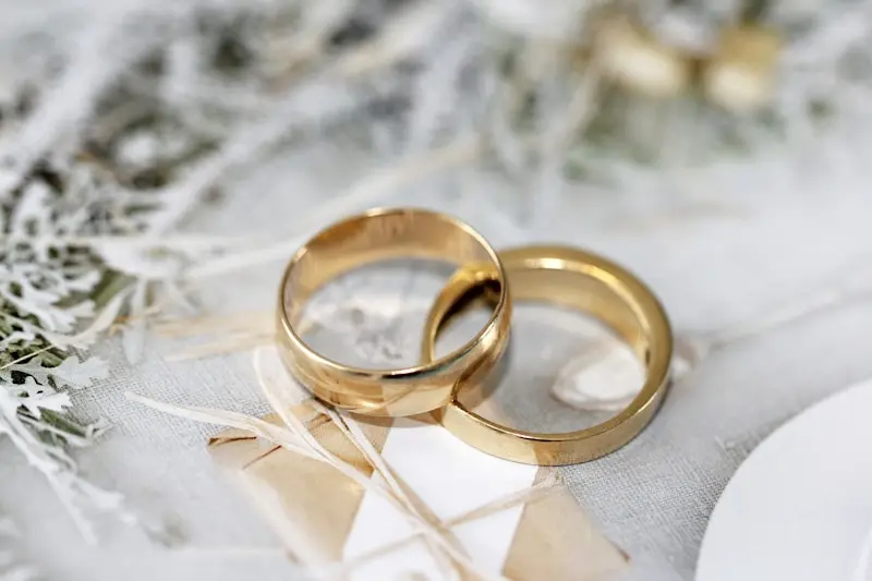 Gold wedding rings on elegant linen for the ceremony